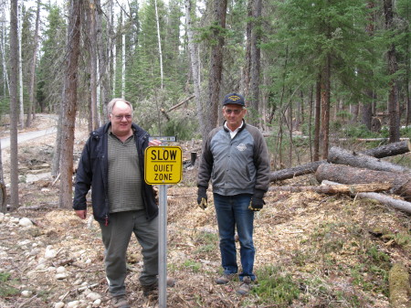 Alex and Don, installing signs in the park, Leroy taking picture
